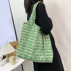 Detail of large canvas tote bag featuring fresh white and green tulip floral patterns