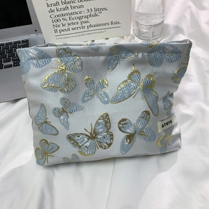 Portable light blue butterfly embroidery brocade cosmetic bag with a sleek silk finish
