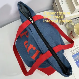 Detail view of denim tote bag with zipper closure and internal small pocket for storage