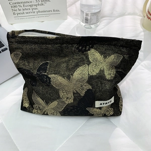 Large capacity black jacquard makeup bag with golden butterfly pattern and zipper closure