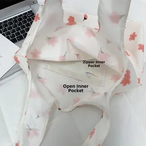 Interior detail of floral tote bag showing zipper pocket and open inner compartments