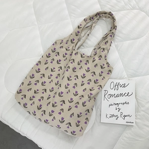 Detail of corduroy tote bag featuring purple tulip prints and soft wide shoulder straps