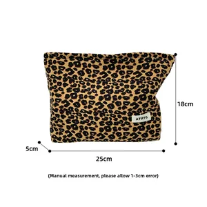 Leopard print canvas makeup bag detail with ATRYG logo label and secure zipper closure