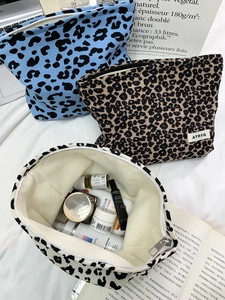 Detail view of large leopard print canvas cosmetic bags with metal zipper closure