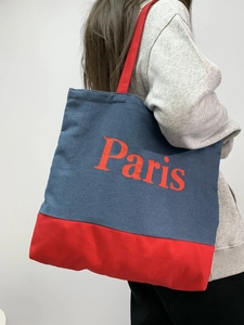 Detail showing red Paris print on blue denim canvas tote bag with contrast shoulder strap
