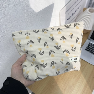 Floral tulip corduroy cosmetic bag in cream white with a portable handheld design