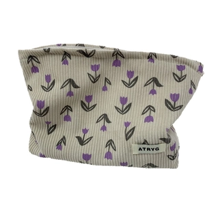 Floral corduroy cosmetic bag with purple tulip patterns and zipper closure for storage