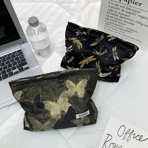 Detail of luxury dragonfly and butterfly jacquard fabric makeup bags with zippers