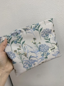 Portable large capacity cosmetic bag with blue hydrangea jacquard and ATRYG woven label