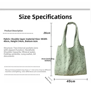 Detail view of mint green tote bag showing floral embossing and interior storage capacity