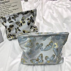 Elegant butterfly pattern makeup bags in black and blue fabric with zipper closure