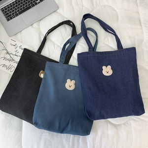 Close-up of denim tote bags in three colors with cute bear and rabbit embroidery