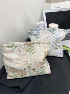 Floral fabric cosmetic bags with ATRYG logo in green and lavender floral patterns