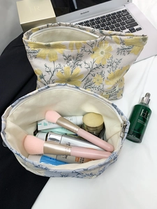 Close-up of floral jacquard makeup bags showing spacious interior for skincare products