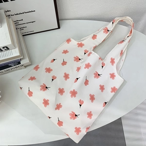 Close-up of floral print canvas tote bag with pink cherry blossom patterns and large capacity