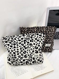 Detailed view of leopard print canvas makeup bags with durable zipper and brand label