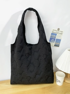 Detail of 3D rose floral embossed texture on a black matte tote bag for women