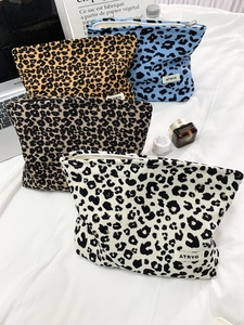 Four-piece set of canvas leopard print makeup bags with zippers and branded patches
