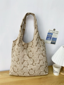 Detailed close-up of beige tote bag featuring 3D rose floral jacquard texture and thick fabric