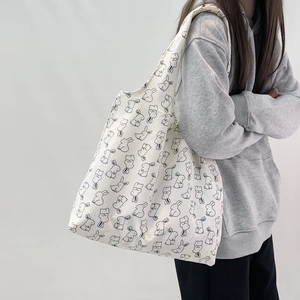 Shoulder canvas tote bag featuring black line art rabbit print on white fabric