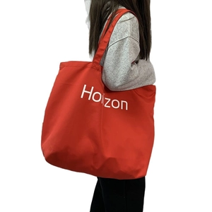 Large red canvas tote bag with Horizon print on shoulder strap for casual daily use
