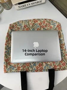 Spacious tote bag with floral print showing size comparison to a 14-inch laptop