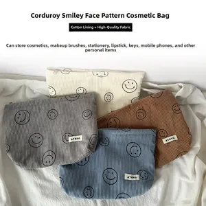 Macro detail of corduroy storage bags in various colors with smiley face embroidery