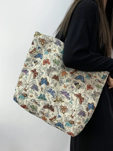 Close-up of vintage floral jacquard tote bag with colorful butterfly patterns and texture