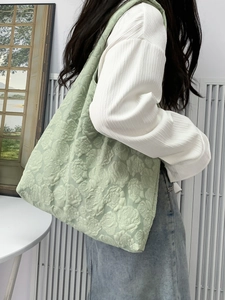 Close-up of mint green tote bag featuring elegant embossed 3D rose flower textures