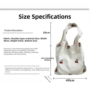 Detailed size specifications of white canvas tote bag with red cherry embroidery detail