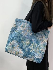 Close-up of Monet style floral tote bag on model showing large capacity and blue patterns