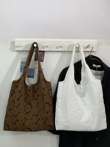 Elegant tote bag with 3D rose floral texture available in dark brown and off-white
