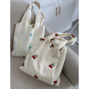 Close-up of cherry and bow embroidery on lightweight tulle tote bags for women
