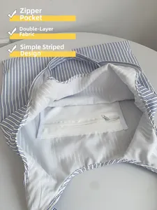 Détail du sac fourre-tout rayé avec doublure double couche et poche intérieure zippée