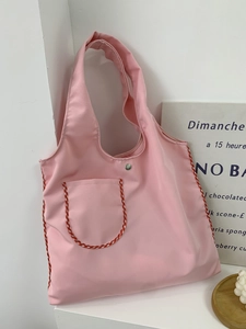 Pink nylon tote bag with red and white gingham trim and a front pocket for daily commute