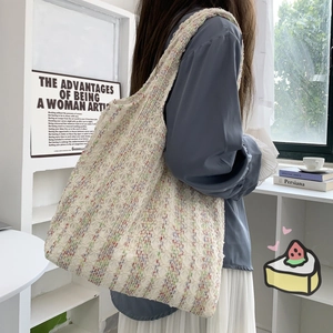 Detailed knit texture of large tote bag with vibrant neon speckled yarn for women