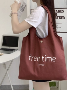 Brick red oversized canvas tote bag with free time lettering and metal snap closure