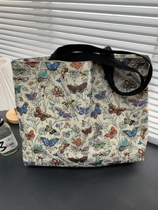 Detail of floral butterfly pattern on a woven tote bag for daily commuting usage