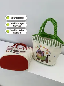 Detail of canvas tote bags with round bottom, woven handles, and dual-sided cartoon prints