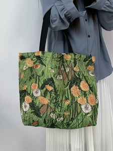Detail of floral jacquard tote bag with blue sunflower pattern and woven straps