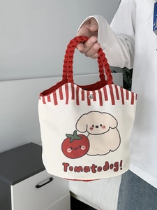Detail of canvas tote bag with red handle, cartoon dog print and silver metal snap button