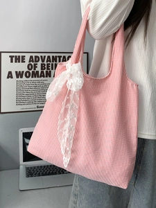 Detail of pink and white seersucker canvas tote bag with a large white lace bow