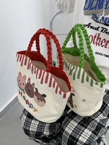 Detail of small canvas tote bags with cute animal prints and secure metal snap buttons