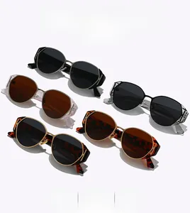 Detail of vintage oval sunglasses showing gold metal hollow hinge craft and colorful frames