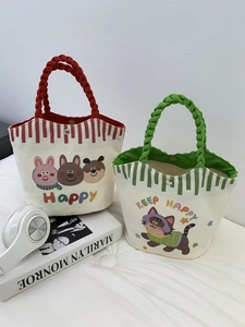 Detail of small canvas tote bags with cartoon prints, woven rope handles and magnetic closure