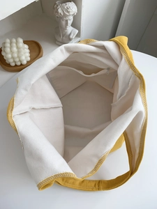 Yellow canvas tote bag with white lining and zipper pocket for daily shopping
