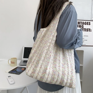 Detailed knit texture of colorful crochet tote bag showing exquisite floral pattern weave