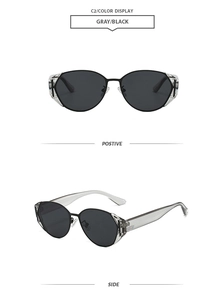 Detail view of oval retro sunglasses with black metal frame and faceted transparent wings