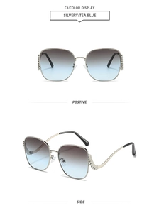 Detail of silver oversized sunglasses with rhinestones and tea blue gradient lenses