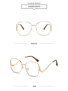 Detail view of gold metal sunglasses frames with sparkling rhinestones and tortoiseshell tips